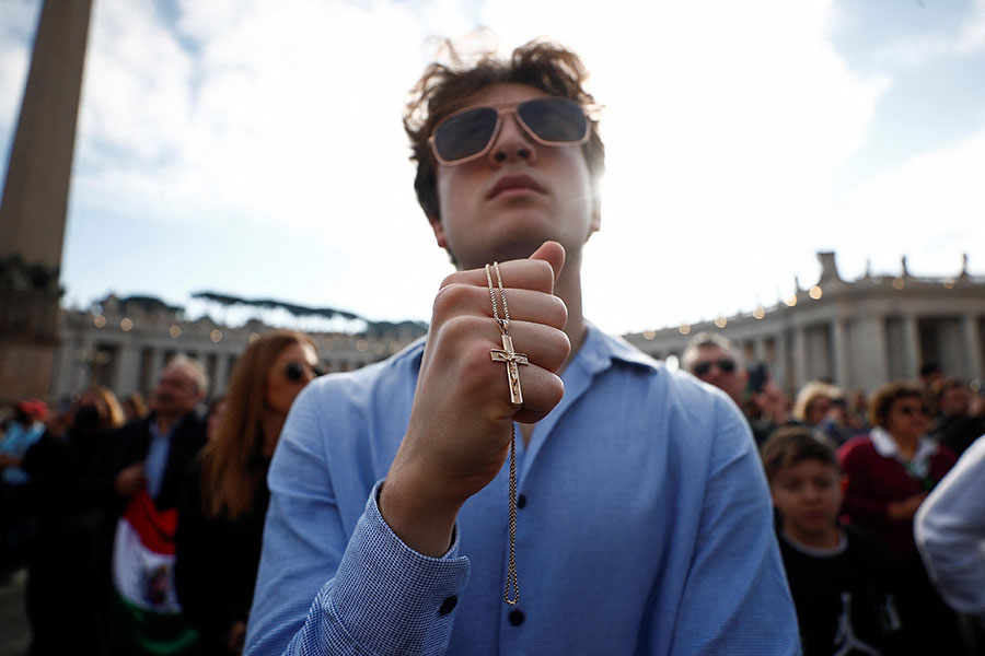 Youth holds a crucifix